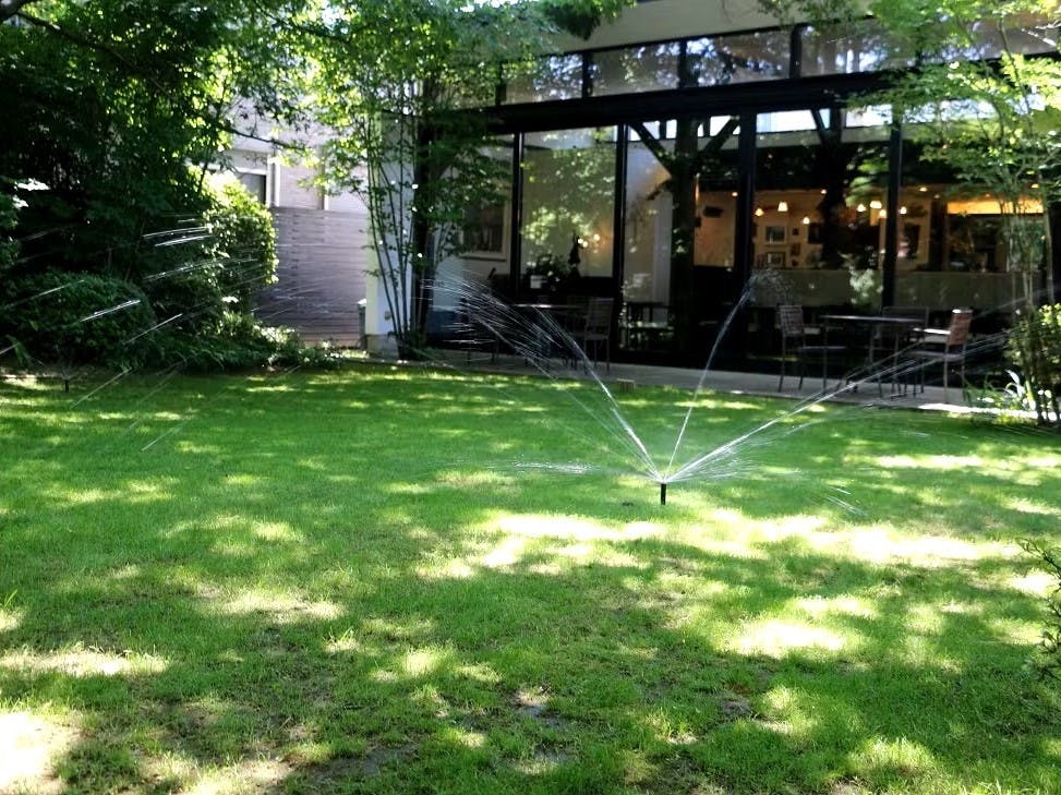 飲食店への施工例　木漏れ日あふれる芝生のお庭にスプリンクラーを導入。